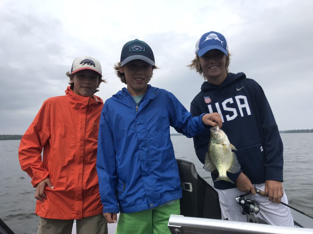 Kids with fish on boat